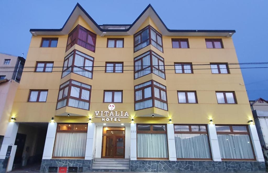 un edificio amarillo con un cartel de hotel en Hotel Vitalia en Ushuaia