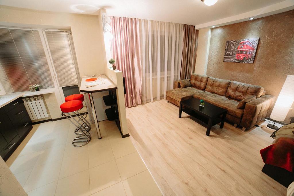a living room with a couch and a table at Apartment on Lenin Avenue in Gomel