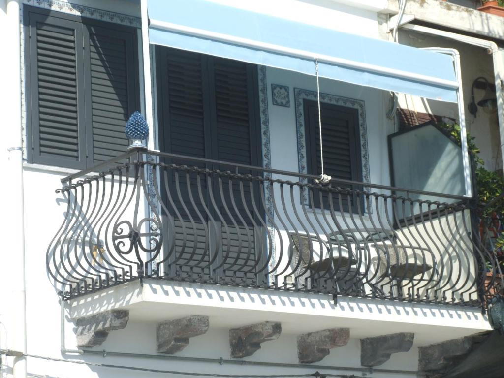 a balcony with an iron railing on a building at CASA NICOLE fronte mare in Giardini Naxos