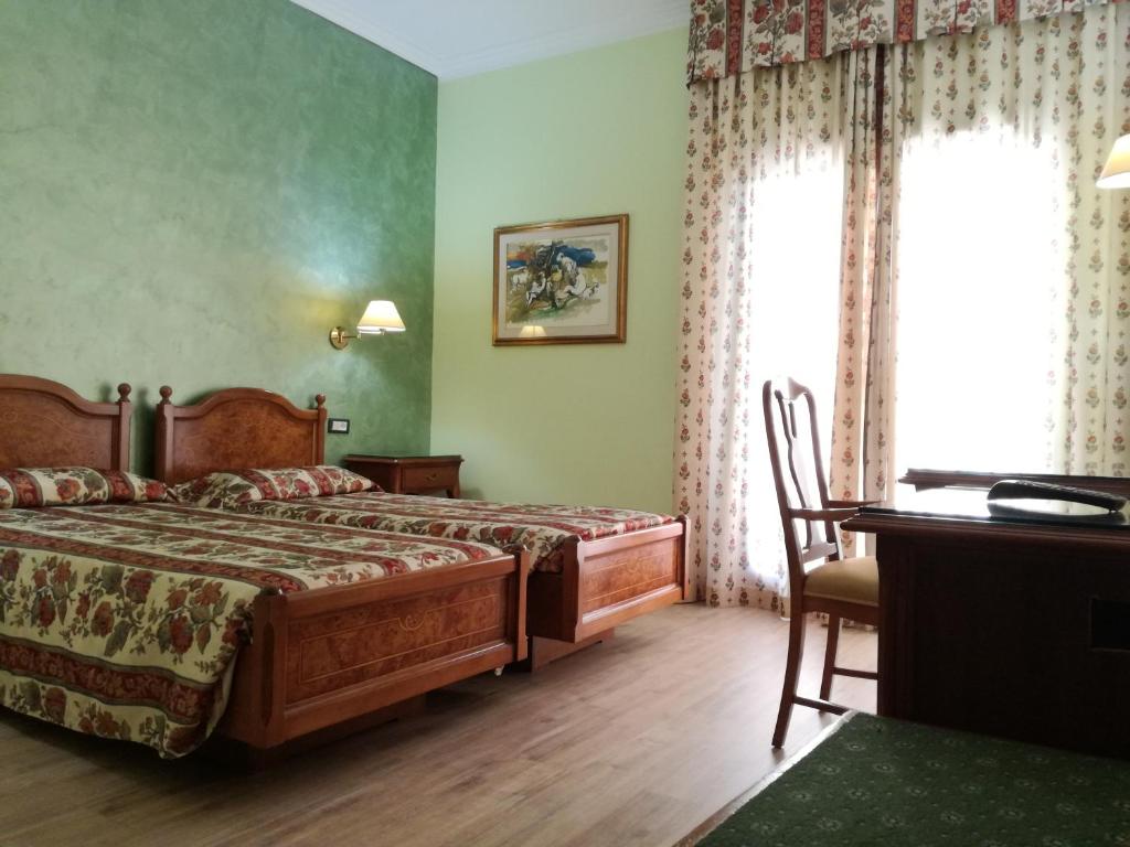 Postel nebo postele na pokoji v ubytování FILIPPONE HOTEL&RISTORANTE