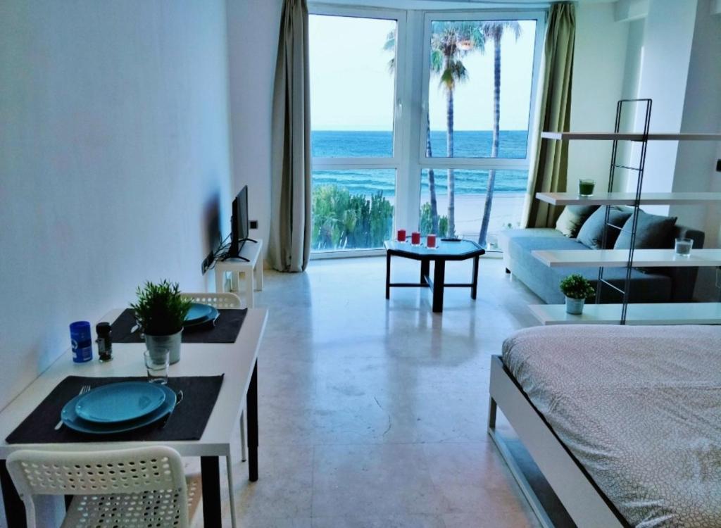 a living room with a bed and a living room with a view at BELLA VISTA in Estepona