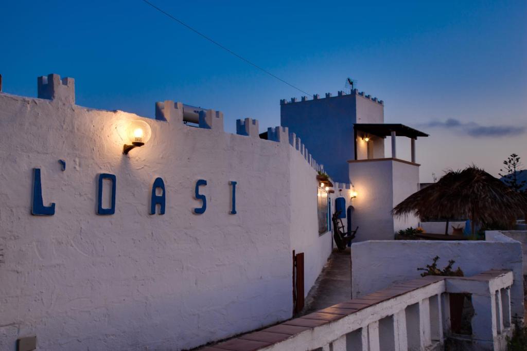 a white wall with the word lassitt on it at L'Oasi Villaggio Albergo in Favignana