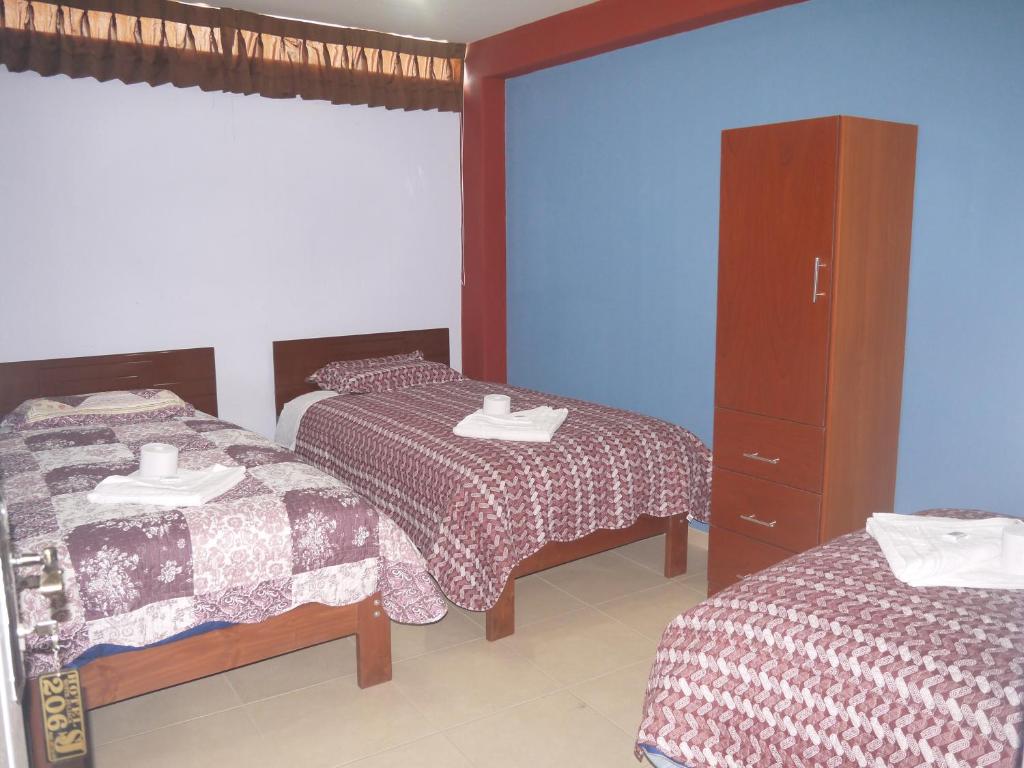 Postel nebo postele na pokoji v ubytování Hotel Suite Juliaca