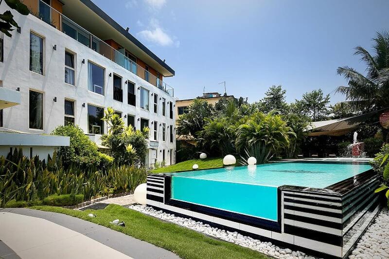 a swimming pool in front of a building at Red Mango Hotel and Apartments in Sekondi-Takoradi