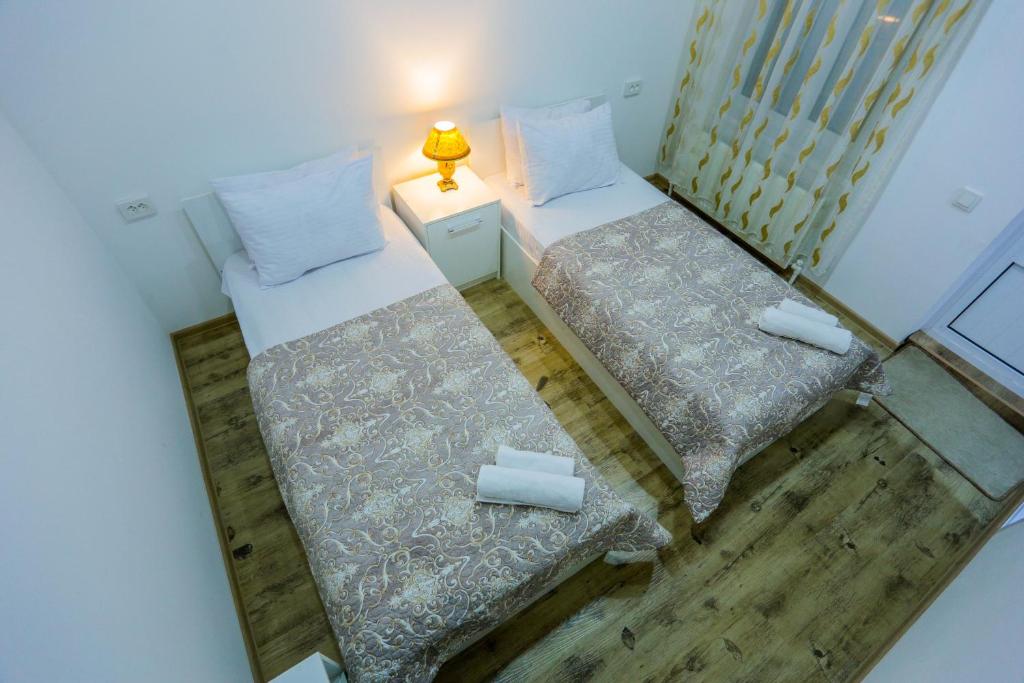 an overhead view of two beds in a room at Hotel Rudakiy Bukhara in Bukhara
