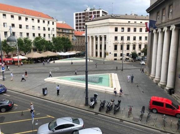 a view of a city street with people and cars at B&B Fontana in Zagreb