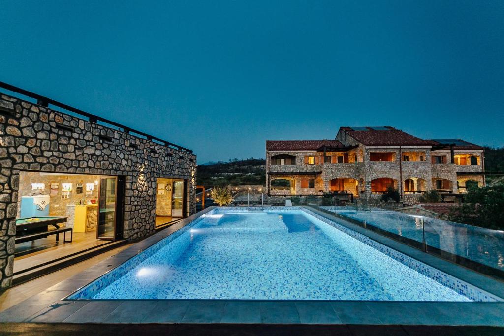 a swimming pool in the middle of a house at Villa Shanti - Pool, Beach & Basketball court in Luštica