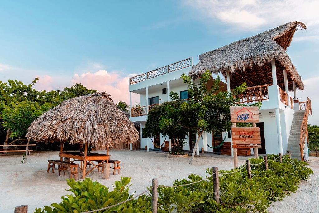 a beach with palm trees and palm trees at Casa Cuyo Hotel, Restaurant in El Cuyo