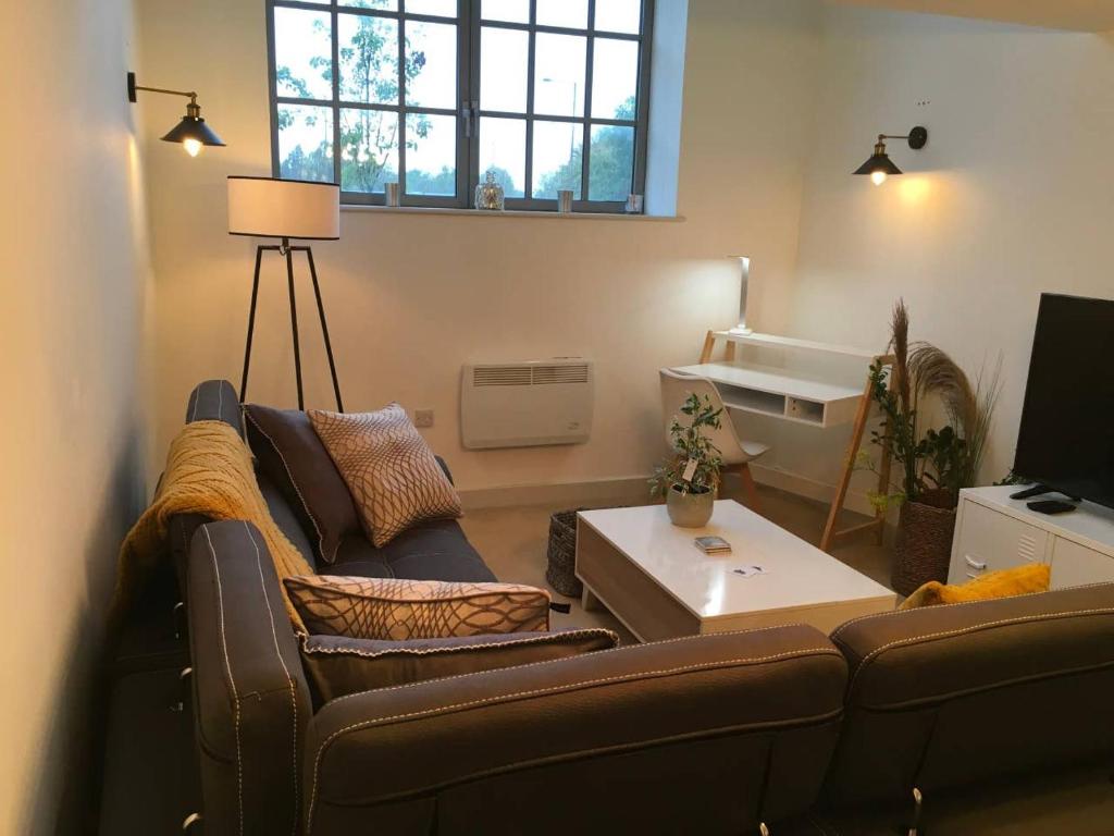 a living room with a couch and a table at The Old Railway Quarter in Swindon