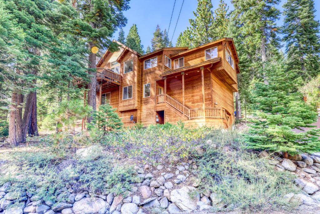 a log home in the woods with trees at Agate Road Retreat in Carnelian Bay