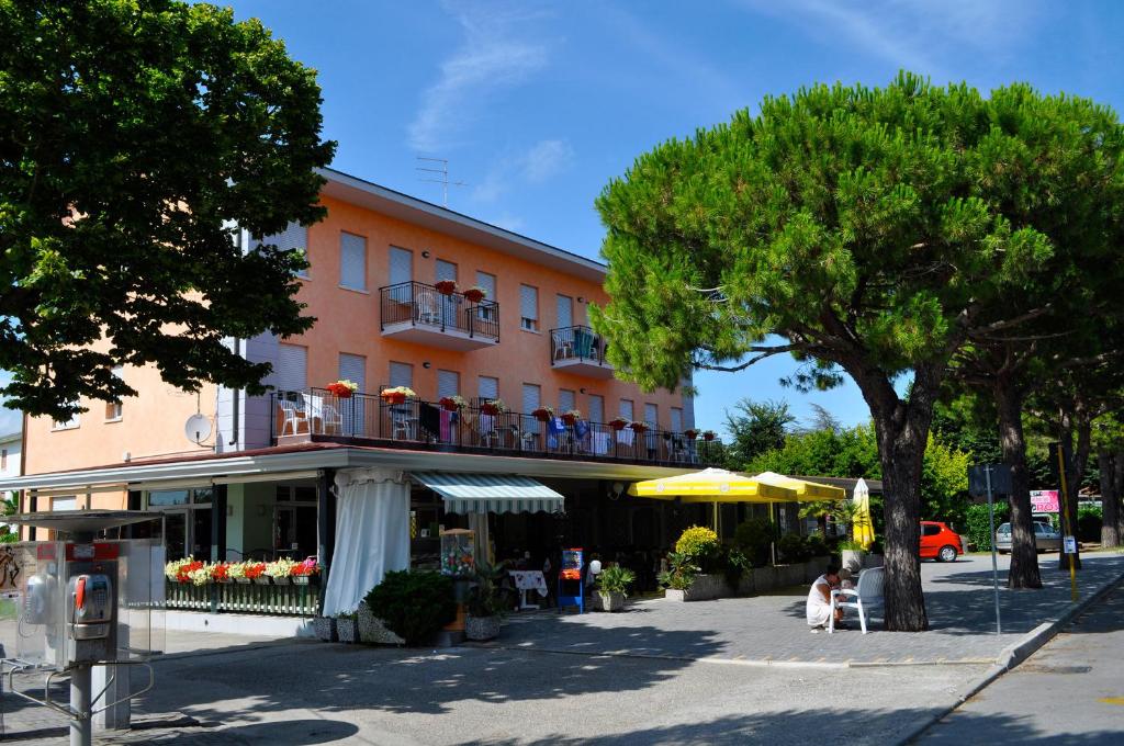 a building with people sitting on a balcony at Albergo Rosa in Cavallino-Treporti