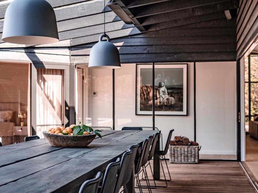 a long wooden table with chairs and a bowl of fruit at Winifred by Kinsfolk in Red Hill South