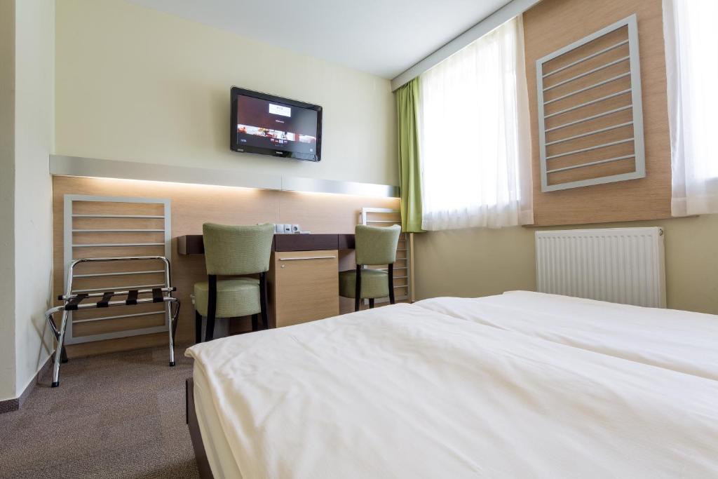 Postel nebo postele na pokoji v ubytování Hotel Center Pokljuka