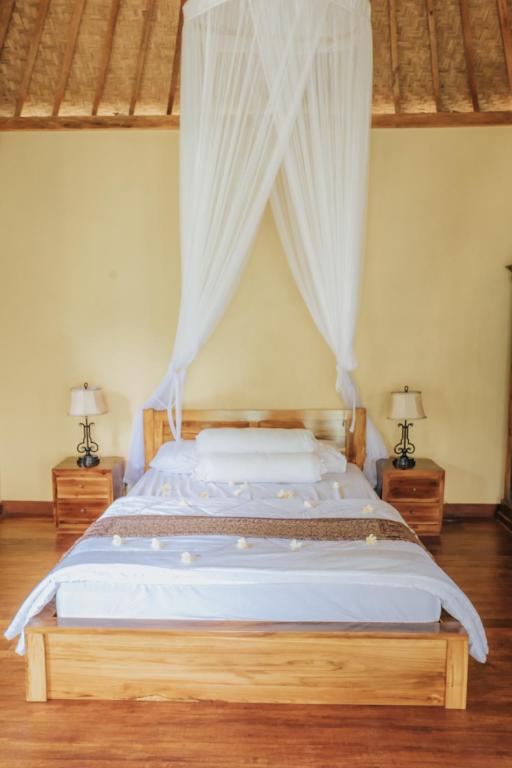 Postel nebo postele na pokoji v ubytování Saridevi Ecolodge