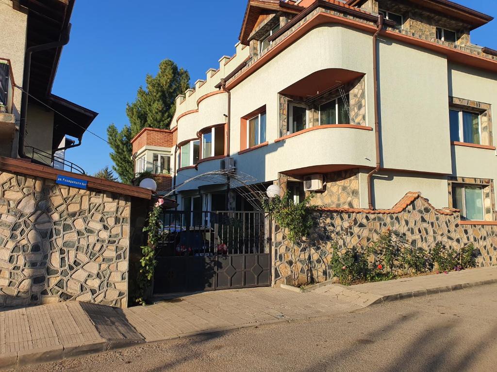 a house with a gate and a stone wall at АПАРТАМЕНТ ЗА ГОСТИ "Момчил'' in Sofia