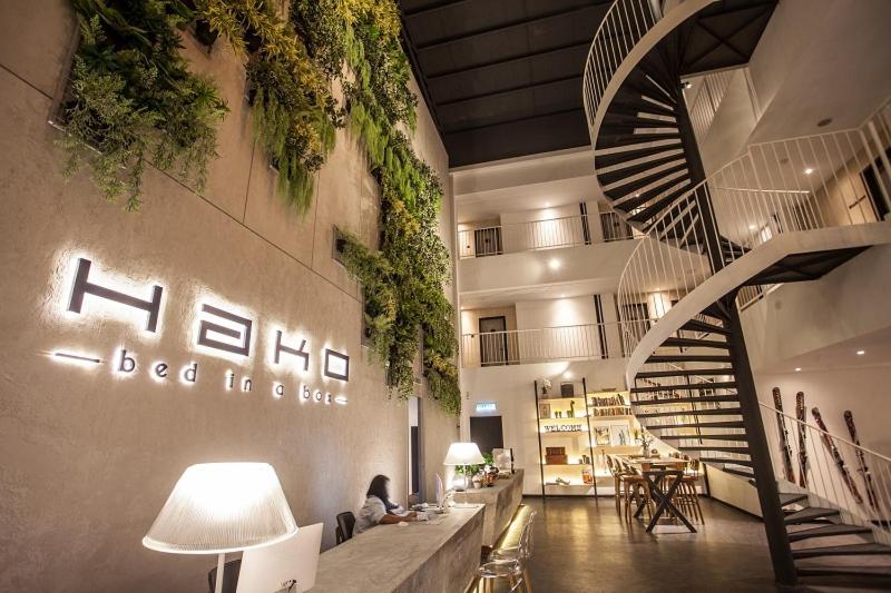 a lobby with a spiral staircase in a building at HAKO HOTEL (MOUNT AUSTIN) in Johor Bahru