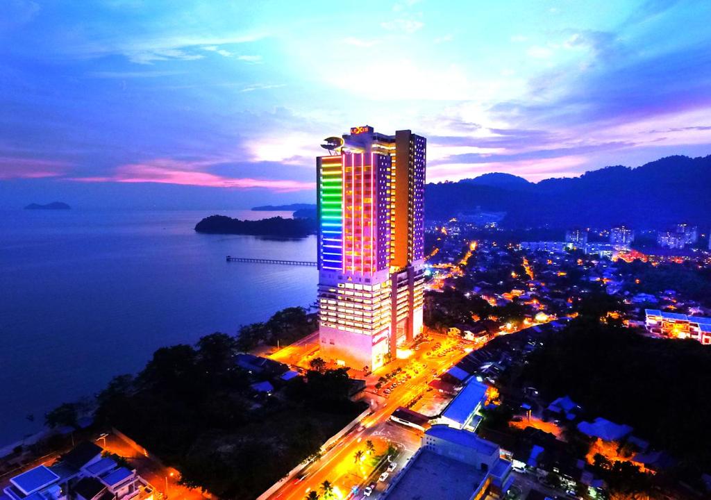 a city at night with a large clock tower at Lexis Suites Penang in Bayan Lepas