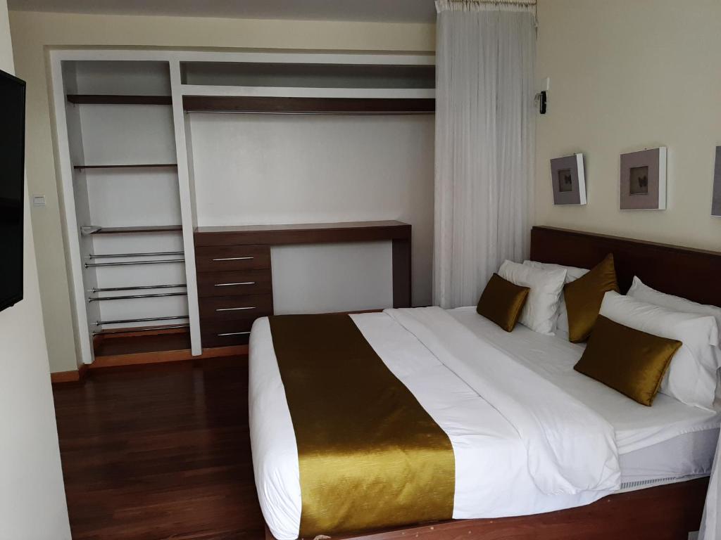 Postel nebo postele na pokoji v ubytování D2W Residency Suites