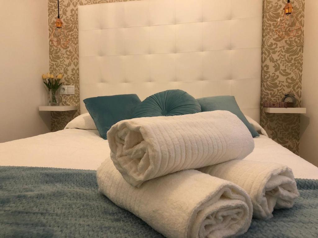 Una pila de toallas encima de una cama en Casa Palacio Polentinos VUT-AV390, en Ávila