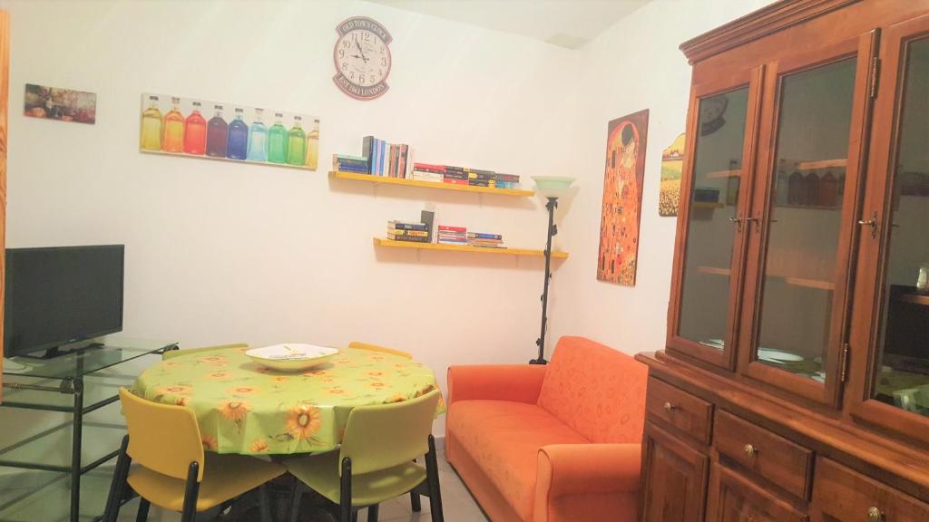 a living room with a table and a couch at Casetta nel centro di Sorgono in Sorgono