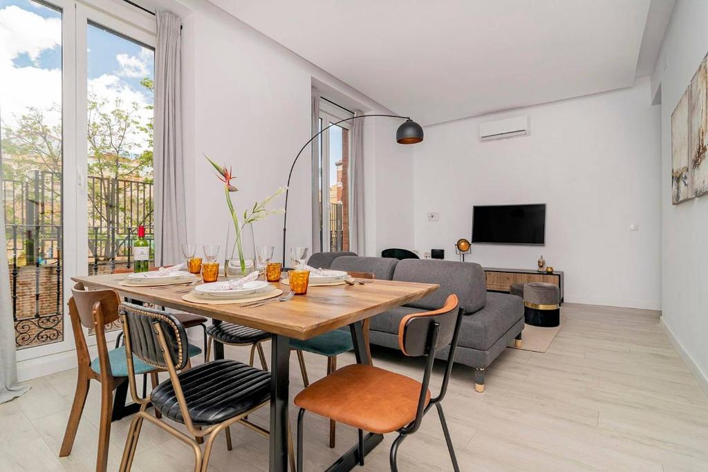 a dining room with a table and chairs and a couch at Apartment with Balconies in La Latina by Batuecas in Madrid