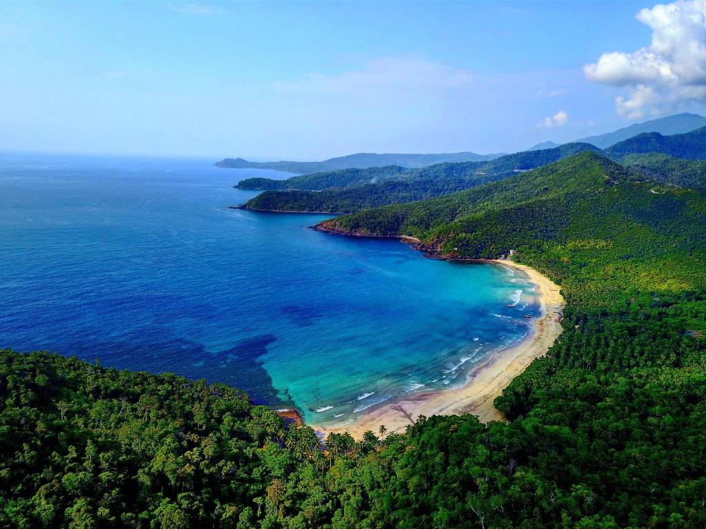 an aerial view of a beach and the ocean at B&R Hostel Nagtabon in Bacungan