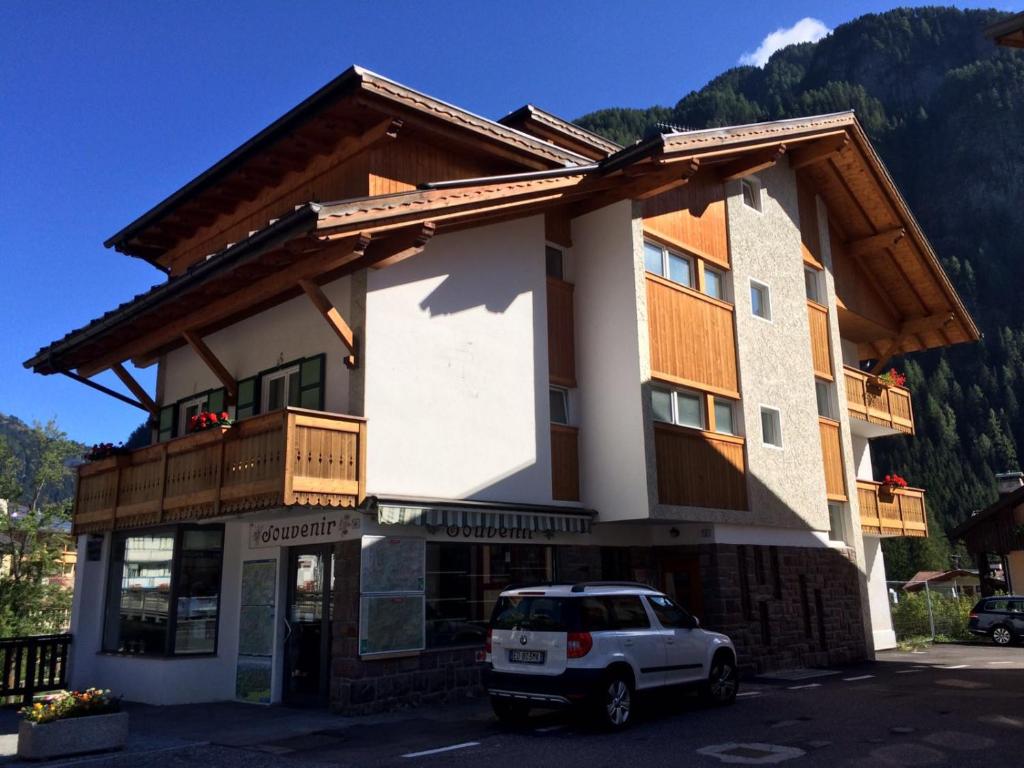 a white car parked in front of a building at Casa Soraruf in Campitello di Fassa