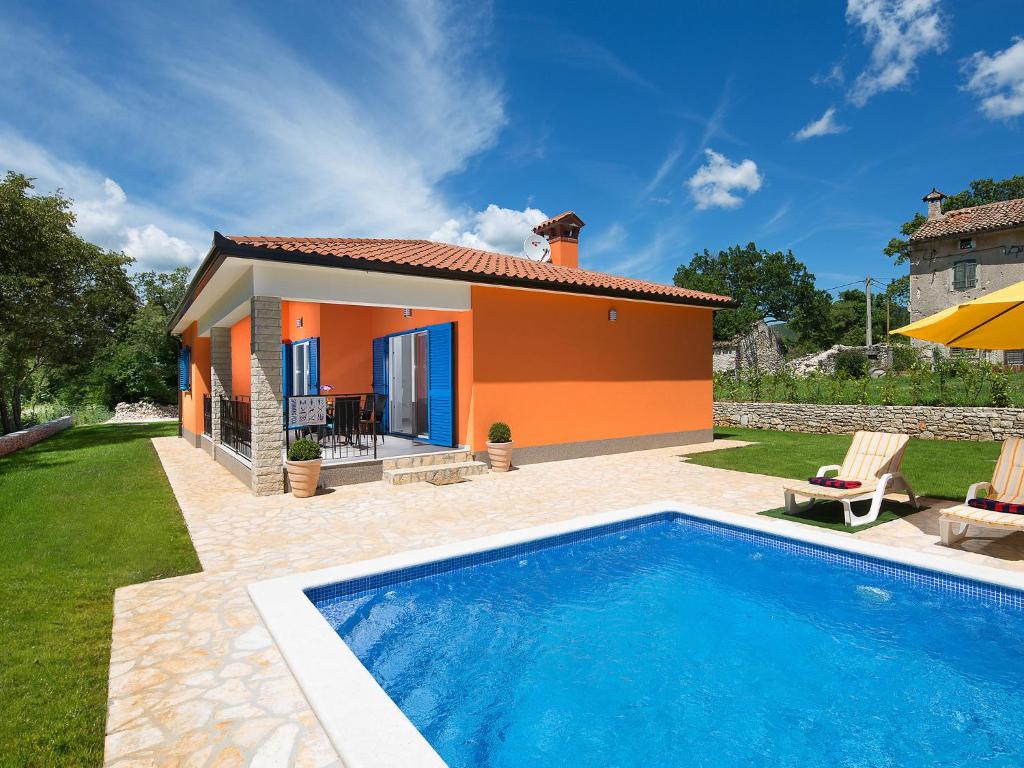 a villa with a swimming pool in front of a house at Holiday Home Ana by Interhome in Trget