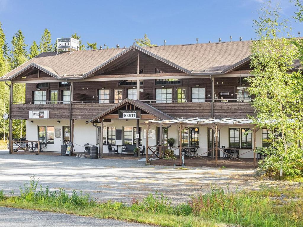 a large wooden building with a lot of windows at Holiday Home Loma tiki by Interhome in Tahkovuori