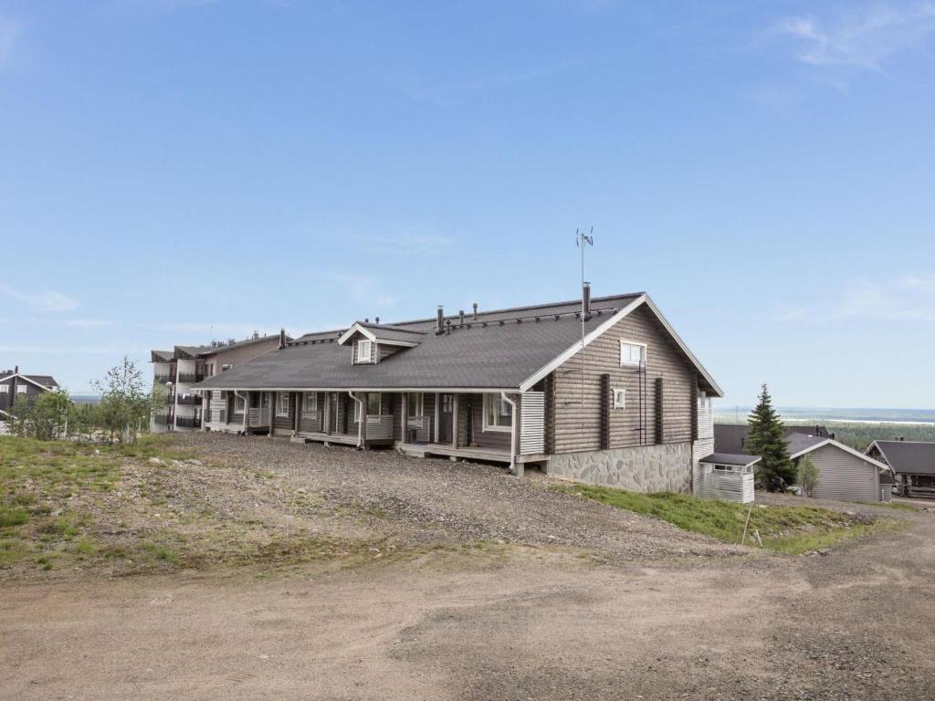 uma casa numa colina ao lado de uma estrada de terra em Holiday Home Ylläksen rinnemäki b by Interhome em Ylläs