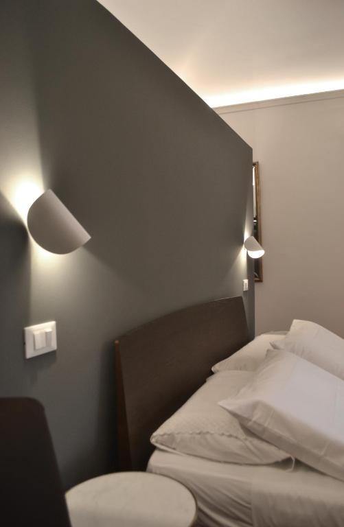 Postel nebo postele na pokoji v ubytování Da Domè Charm Rooms