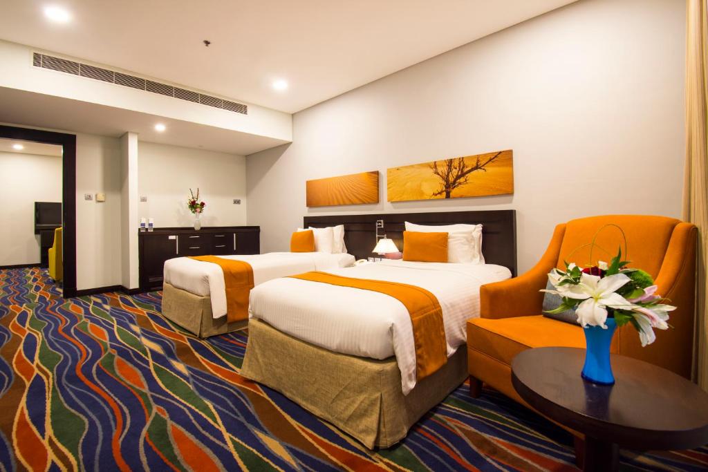 Postel nebo postele na pokoji v ubytování City Seasons Hotel & Suites Muscat