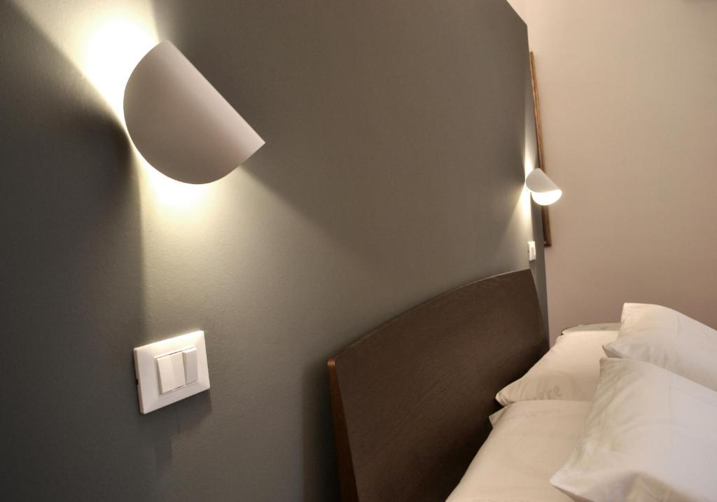 Postel nebo postele na pokoji v ubytování Da Domè Charm Rooms