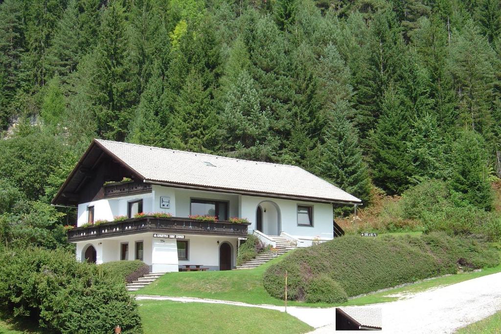 a house in the middle of a mountain at Apartments Balon in Kranjska Gora