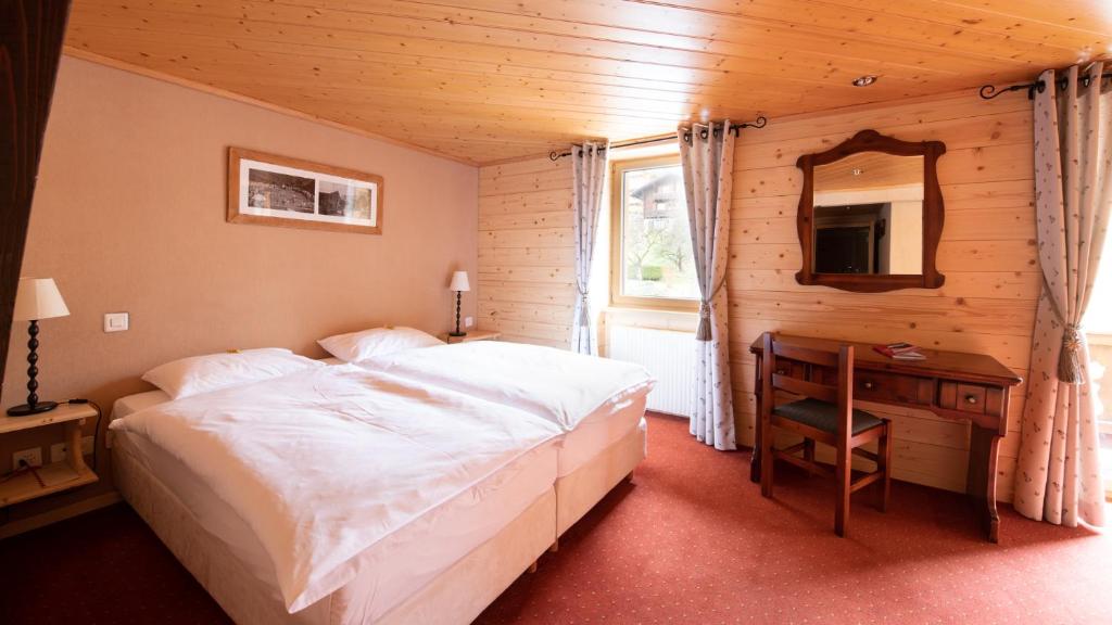 Postel nebo postele na pokoji v ubytování Hotel Suisse