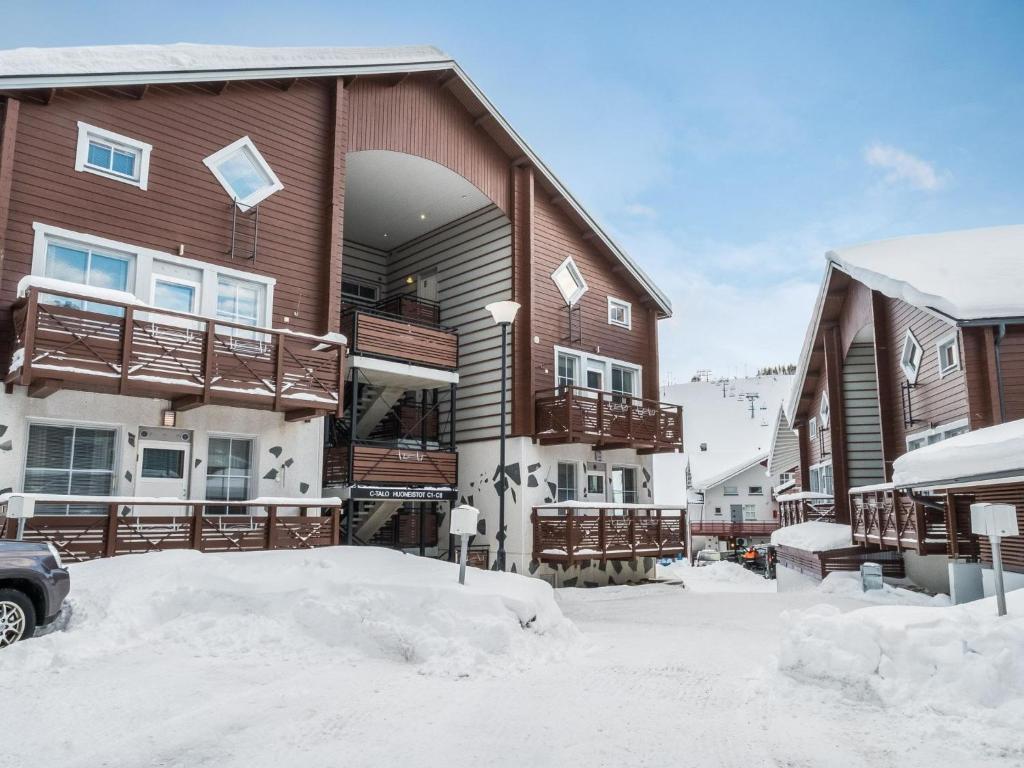 a house with snow on the ground in front of it at Holiday Home Levinkolmio c5 by Interhome in Sirkka