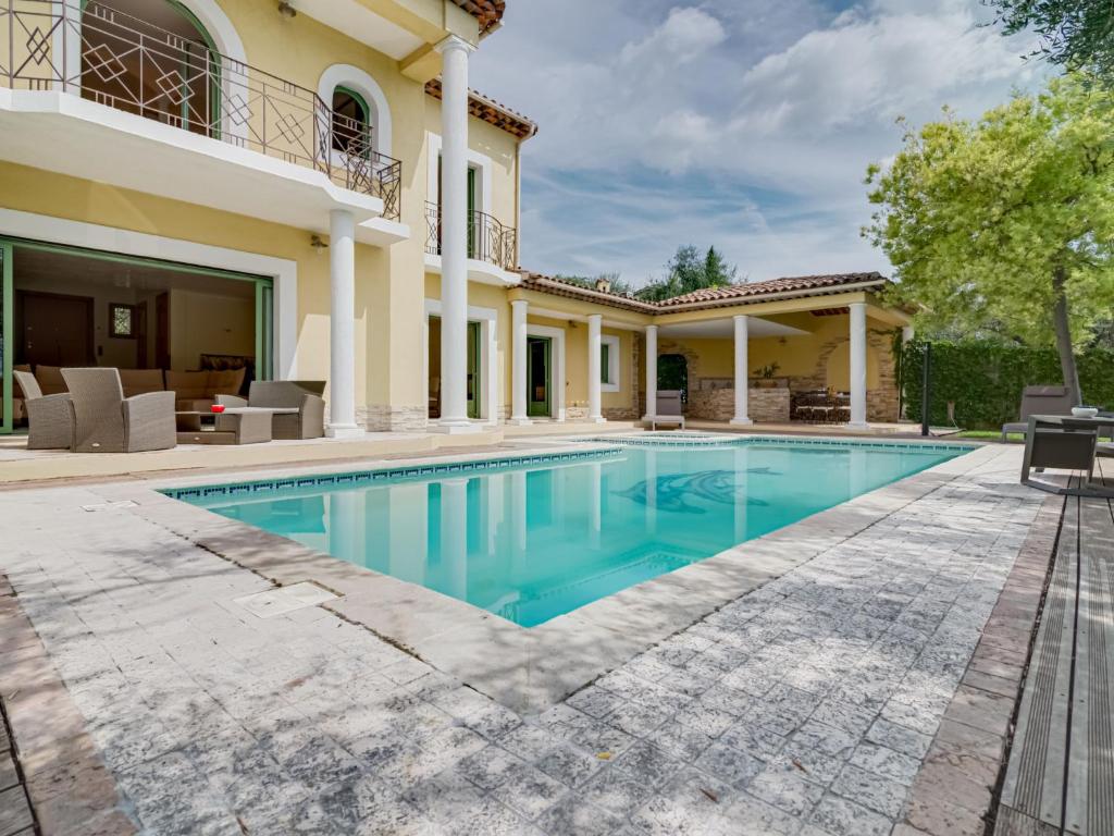 a swimming pool in the backyard of a villa at Villa Caliopa by Interhome in Grasse