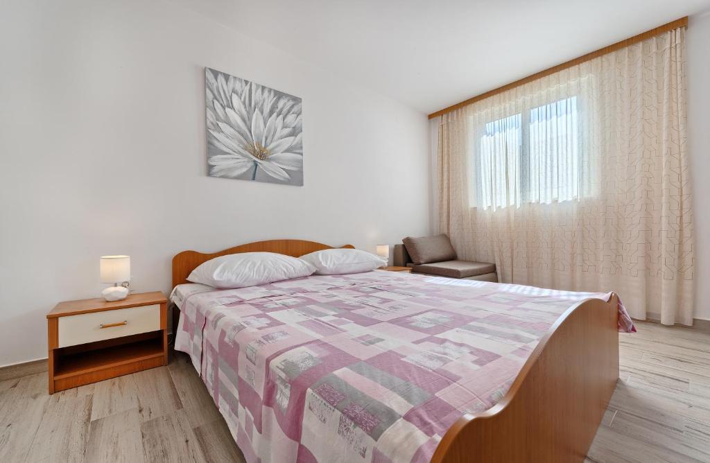 Postel nebo postele na pokoji v ubytování Apartmani MARINA