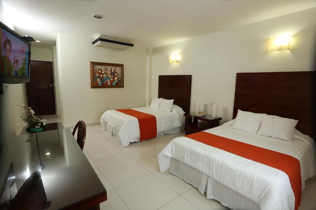 Postel nebo postele na pokoji v ubytování Hotel Marel