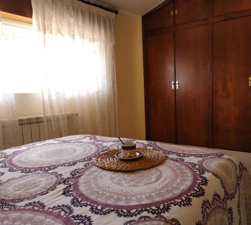 a bedroom with a bed with a tray on it at Casa Pereusos in Louro