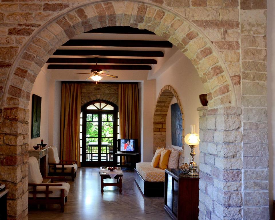 an archway in a living room with a stone wall at Villa Petra in Kalamaki Messinia