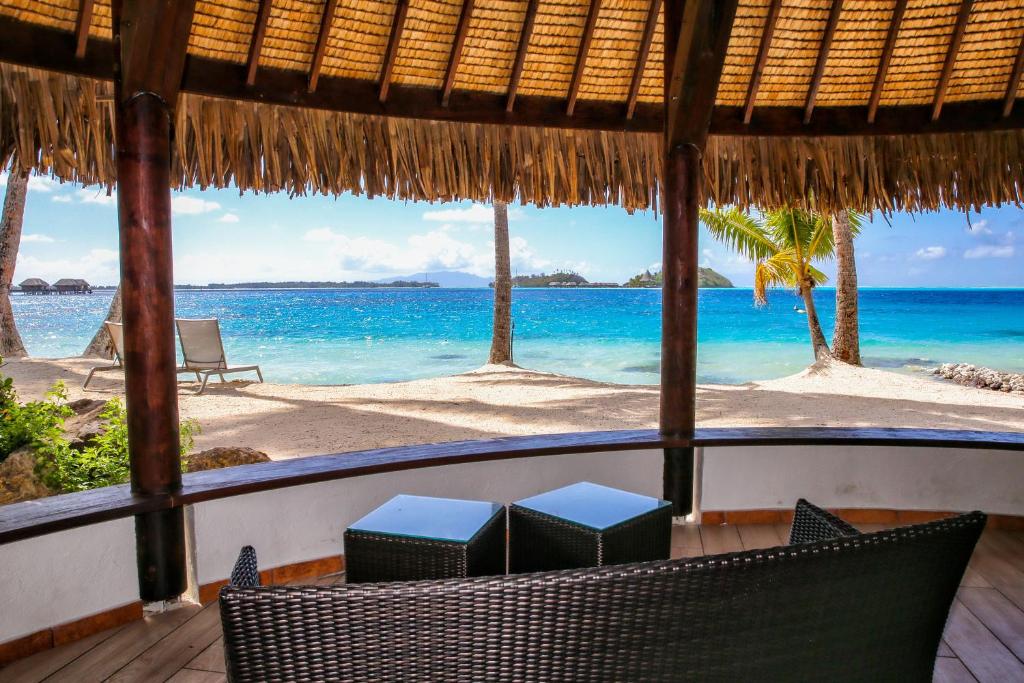 a view of a beach with chairs and the ocean at ROYAL BORA BORA in Bora Bora