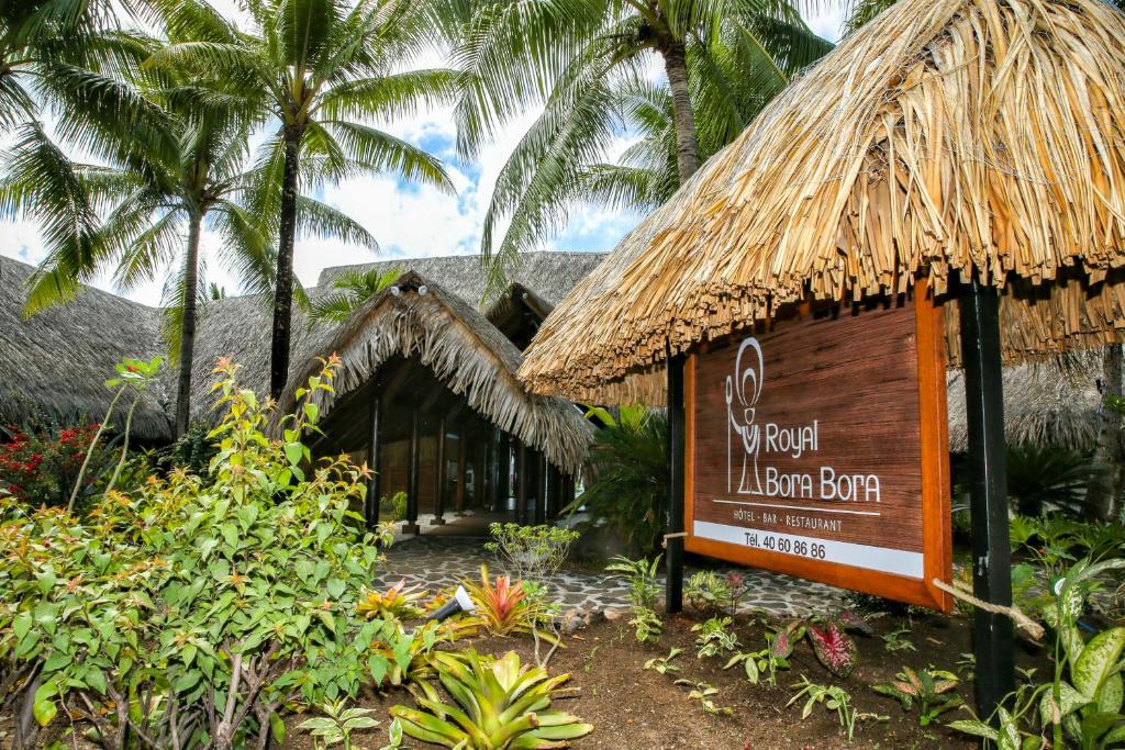 a sign in front of a resort with palm trees at ROYAL BORA BORA in Bora Bora