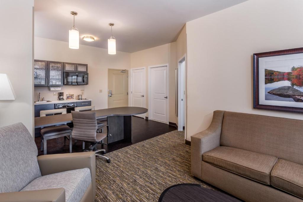 a living room with a couch and a table at Candlewood Suites Bethlehem South by IHG in Bethlehem