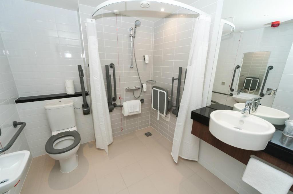 a bathroom with a toilet and a sink and a shower at Holiday Inn Express Aberdeen Airport by IHG in Dyce