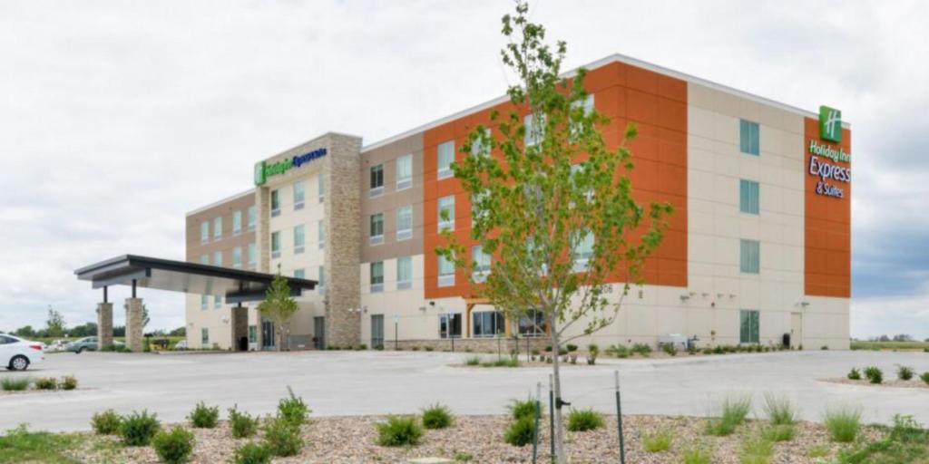 a building with a car parked in front of it at Holiday Inn Express - Alliance, an IHG Hotel in Alliance