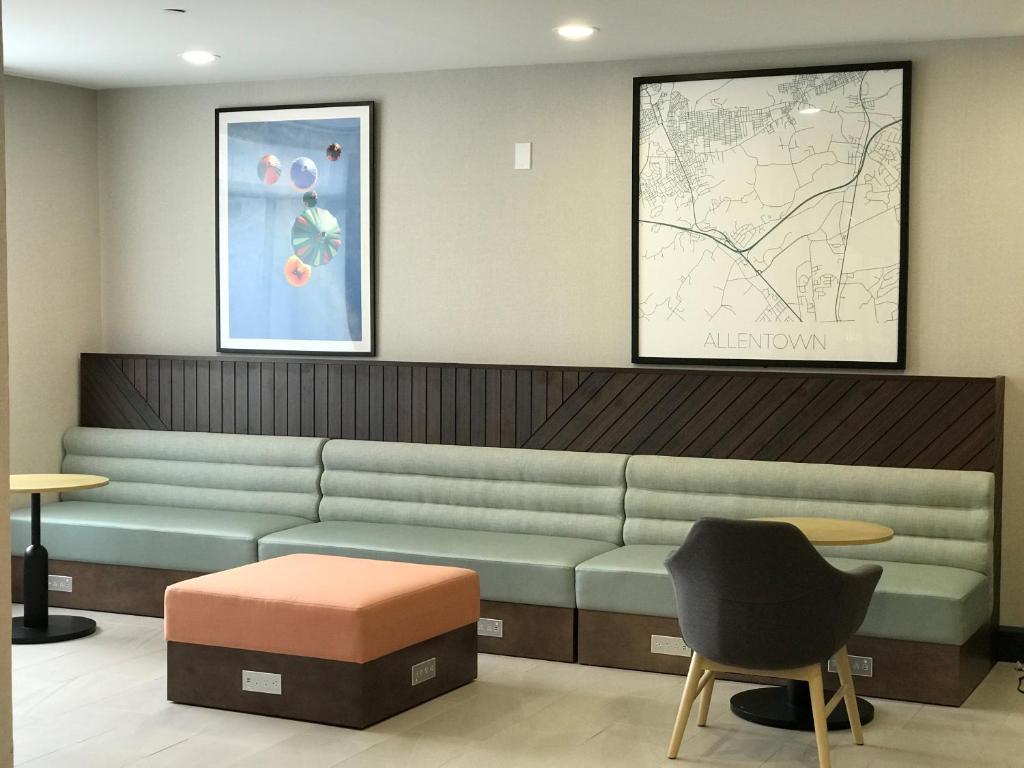 a waiting room with a green couch and a chair at Holiday Inn Allentown-Bethlehem by IHG in Allentown