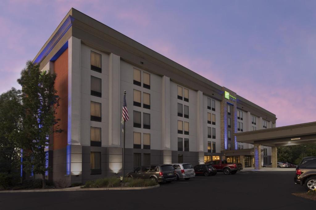 a hotel building with cars parked in a parking lot at Holiday Inn Express Andover North - Lawrence, an IHG Hotel in Lawrence
