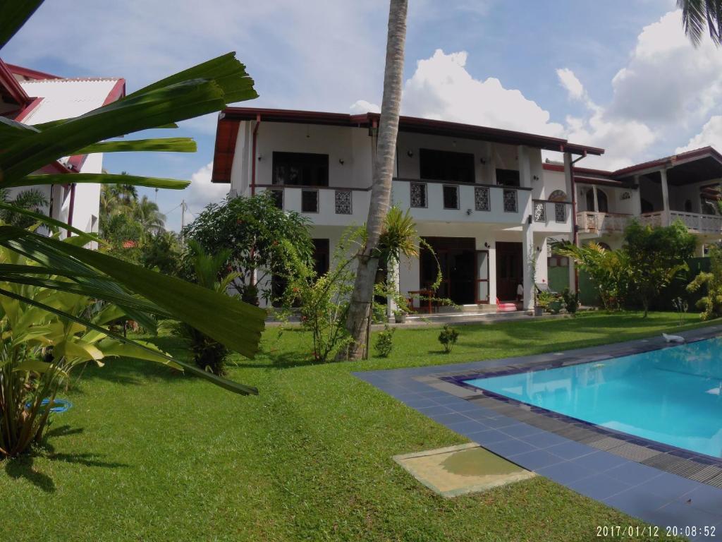 a view of the villas from the pool at Villa Riverplace in Beruwala
