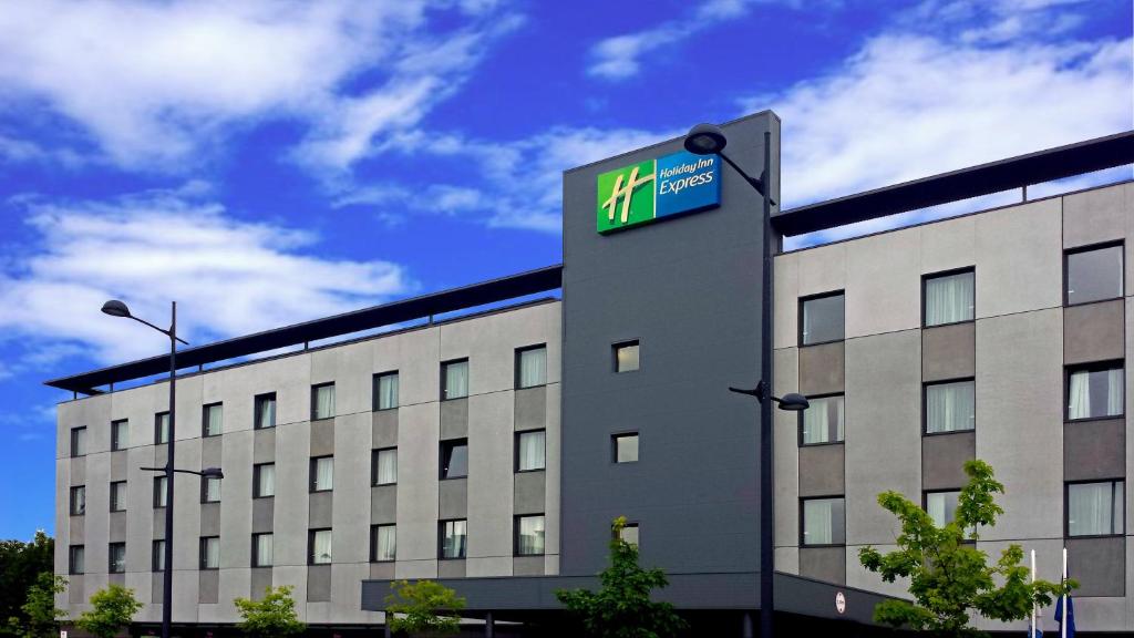 
a building with a clock on the front of it at Holiday Inn Express Bilbao Airport, an IHG Hotel in Derio
